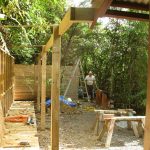 Bruce passing the privacy screen to enter the new Chao Khun kuti courtyard. The meditation walking path (left) yet to be walled and roofed. A bit more landscaping to come.