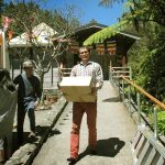 Lim carrying books. Young and May getting the coffee cart ready. New handrail - at right - ready and waiting.