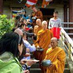 Luang Por Poi leads the sangha on pindapat. The sun shines on us all.
