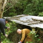 Venerable Aruno and Lam Nam tidying and adding to our firewood supply.