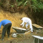 Sebastian and Marcel trimming back the bank at the Chao Khun kuti to clear a straight line for the meditation walking path.