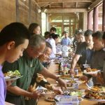 The community shares the Magha puja meal.