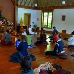 The retreat has almost ended. The Sangha chant blessings.