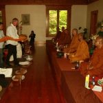 Simon and members of the monastery committee carry the Kathina-season cloth forward to present to the Sangha.