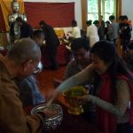Many of the monastery Buddha images (rear) being bathed while venerable Kusalacitto receives a blessing.