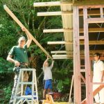 The roof is almost on and the final rafter is fitted. Aunty Suan keeps an eye on progress.