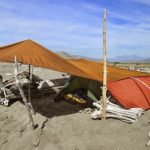 Cape Trip: Ajahn Kusalo opted for beach camping at Rangitukia. The hot sun required some creative robe adjustments.