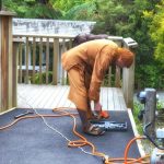Ajahn Ariyasilo finishing off the top end of the fence alongside the kitchen.
