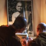 Ajahn Chah oversees a sewing demo.