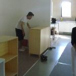 Ajahn Kusalos son (left) helps with the installing of the new cabinets. Suan is right.