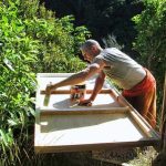 Ajahn Kusalo painting the underside of the bed-thing for his new kuti (renovated triplex).