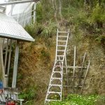 Vieng clearing the top of the bank at the upper house in preparation for the formation of the new patio area.