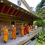 The Sangha circumambulates the sala with several hundred lay people following behind.