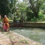 Passing through a small village to collect alms. Another waterway.