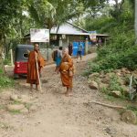 After pindapata we visit the local temple. The man in the blue sarong (carrying my bag) supports one of the kutis in the forest. He was very helpful.