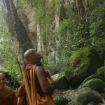 Ajahn Damita looks upward in disbelief. "That is not an impassable cliff..." Venerable Sumangala can see the funny side. We are lost.