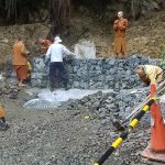 Putting the finishing touches to the gabion retaining wall at the base of the landslide.