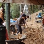 The vihara basement gets a team effort in leveling the floor ready for a concrete slab.