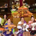 Ladies well prepared with robes to offer to the Sangha.