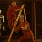 Venerable Appamado steadies the ladder for Ajahn Thitasippo.