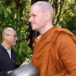 Venerable Phasuko quietly waits in the pindapat line.