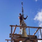 On a ladder resting on planks which straddle the handrail our intrepid ajahn effects repairs.