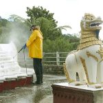 Drew water blasting the stupa in preparation for painting.