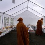 Monks receiving and sorting alms offerings. It was generally agreed that the new food tent was useful... you will see it again.