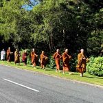 The resident sangha walk on alms round down Stokes Valley Road to start the new year.