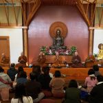 The sangha chant parittas.