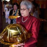 Sarina circumambulating the sala with her kathina offering.
