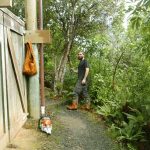 Bryce with machete poised ready to start clearing wheeled access to the vihara basement level.