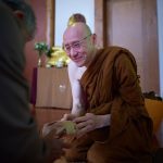 As a fully ordained samanera venerable Appamado receives some offerings from the laity.