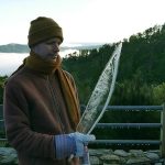 Venerable Thanavaro holds an ice scimitar lifted from the tarp covering the stupa. Yes it was a cold morning.