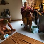 Ajahn Kusalo trying to remember how to do a french seam. Venerable Kusalacitto prepares the two pieces of the kathina robe ready for joining.