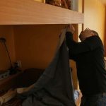 Kheng working on curtain installation in Ajahn Kusalos kuti.