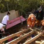 Nuk and Vipha working on getting the track grade right. The monks are building the kuti sub-floor.