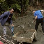 Builders mix being loaded into the quad trailer to be taken up to the vihara.