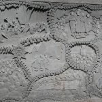 Three large stone panels surround the stone pillar depicting Luang Por Chahs life (work not finished). Center ajahn Chah with ajahn Sumedho and Khemmanando.