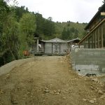 The driveway retaining wall has been formed and the drive is being filled.