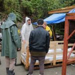 The Buddha rupa is being released from the crate.