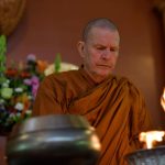 The names of deceased family members are burned while the Sangha chants Anicca vata sankhara...