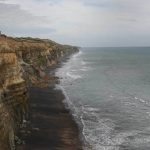 Tudong: A rugged coastline runs south.