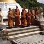 The stone is down and the Sangha looks on.