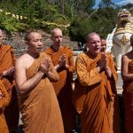 The Sangha chant paritta while the box of blessings is filled.