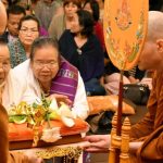 Venerables Thanavaro and Phasuko receive the Kathina cloth on behalf of the Sangha.