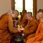 The cloth is offered to Ajahn Kusalo.