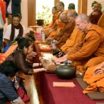 Robes and other requisites are offered to the sangha.