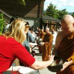 Ajahn Kalyano collects rice on pindapat.