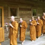 The Sangha leads the circumambulation around the sala.